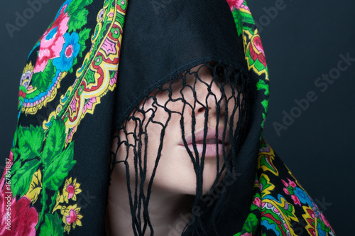 Female model with face covered by scarf