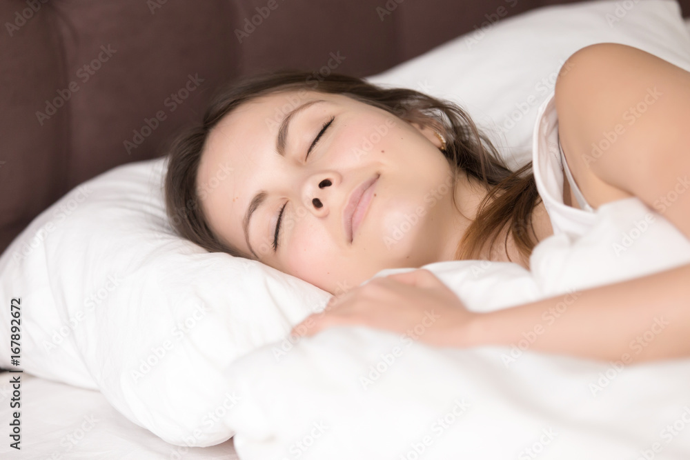Pretty girl resting in cozy bed, enjoying good deep healthy sleep for beauty rejuvenation, sleeping on white cotton linen, falling asleep lying on soft pillow, seeing sweet dreams, close up head shot Pretty girl resting in cozy bed, enjoying good deep healthy sleep for beauty rejuvenation, sleeping on white cotton linen, falling asleep lying on soft pillow, seeing sweet dreams, close up head shot