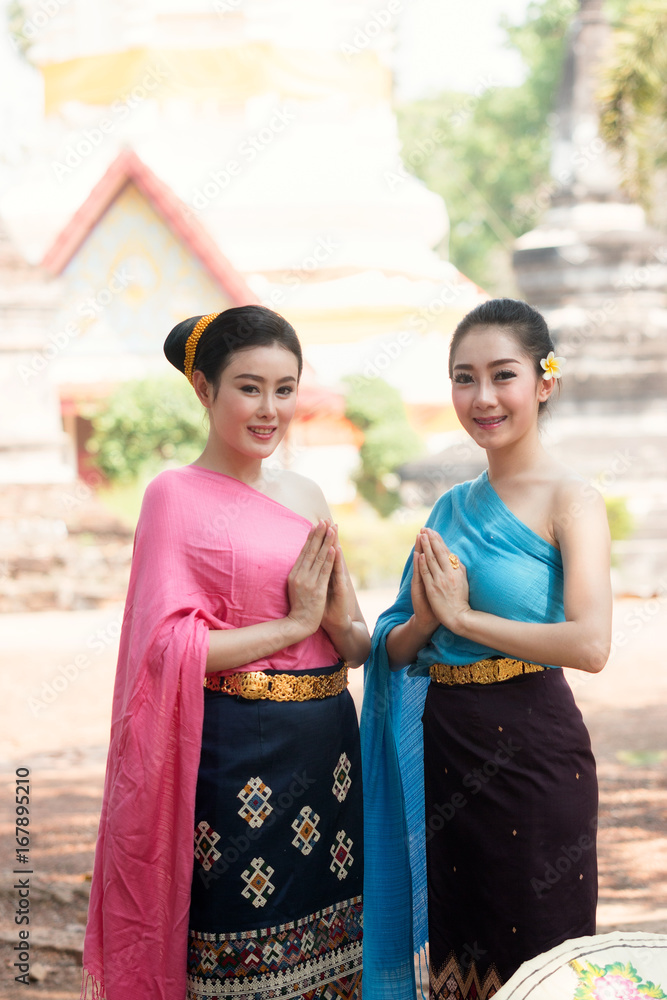 Beautiful Laos girls in traditional Lao traditional dress are standing at  temple,Luang Prabang,vintage style,traditional suit. Stock Photo | Adobe  Stock