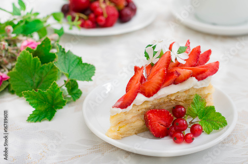 Napoleon cake with strawberries. Wooden background. Close-up. Top view