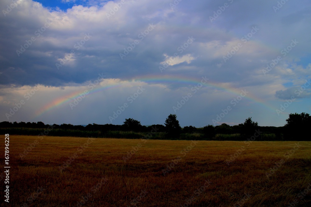 Rainbow over field near small town Stupava, Záhorie, Slovakia