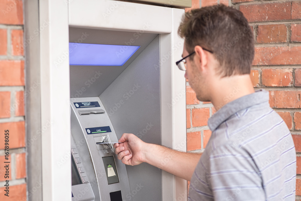 Man using ATM bank machine Man using ATM bank machine