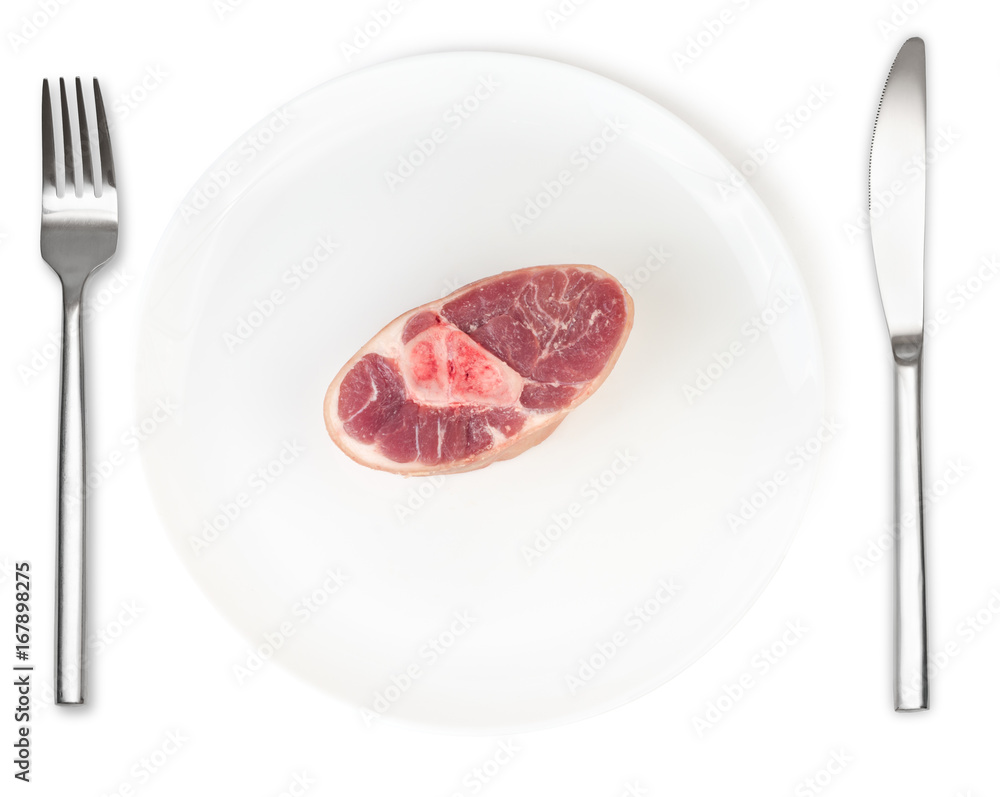 Raw pork knuckle on plate with fork and knife isolated Raw pork knuckle on plate with fork and knife isolated