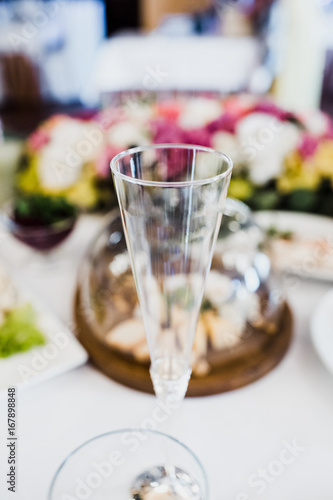 Empty champagne flute stands on the table