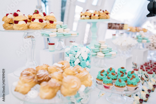 Candy bar with macaroons, eclairs, chocolate cakes