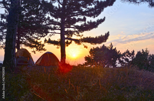 Background of camp over sunrice in mountains in morning
