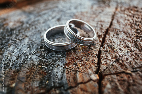Wedding rings lie on a wooden block