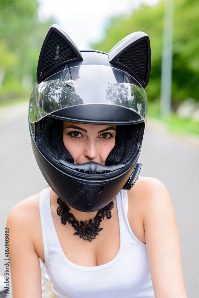Beautiful girl in motorcycle helmet.