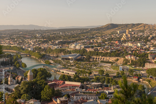 Fototapeta Naklejka Na Ścianę i Meble -  Tbilisi, Georgia - July 15, 2017: Panoramic view of old Tbilisi city in the sunny evening