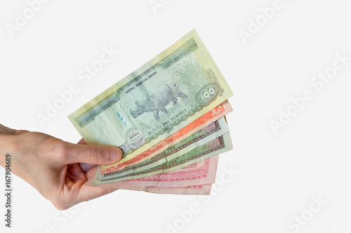 Woman holding Nepal Rupees notes in her hand