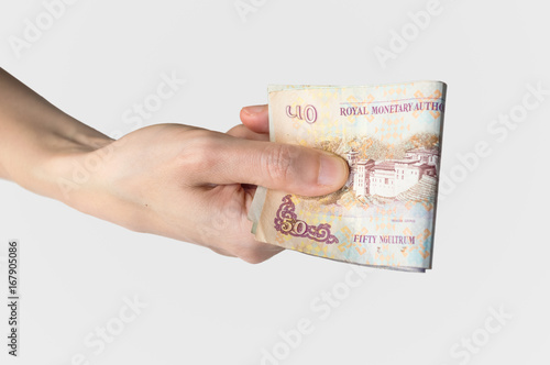 Woman holding  Bhutanese Ngultrum notes in her hand photo