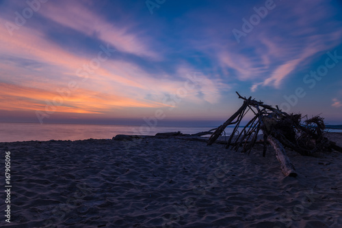 Branch wooden house on tropical beach in sunset time, deserted beach © michalchm89