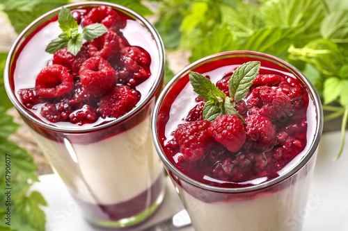 Pana cotta with mint and raspberries with fruit topping photo
