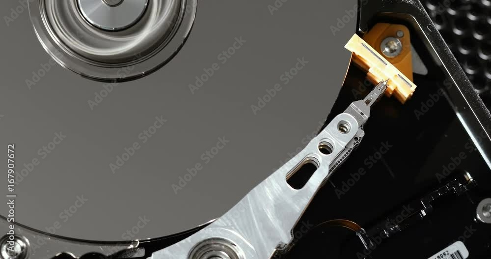 Operating hard disk drive on dark background. Operating hard disk drive on dark background.