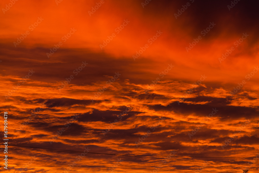 Fototapeta premium Red voluminous clouds at sunrise