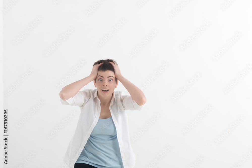 Headshot of hysterical Caucasian freckled student girl looking in despair and panic, being late for important exam or event, not knowing what to do, hands on her head, mouth wide open Headshot of hysterical Caucasian freckled student girl looking in despair and panic, being late for important exam or event, not knowing what to do, hands on her head, mouth wide open