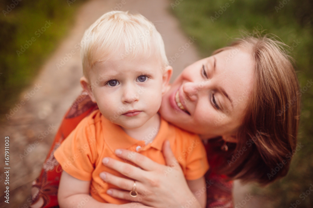 Happy mother holds beautiful little son tender Happy mother holds beautiful little son tender