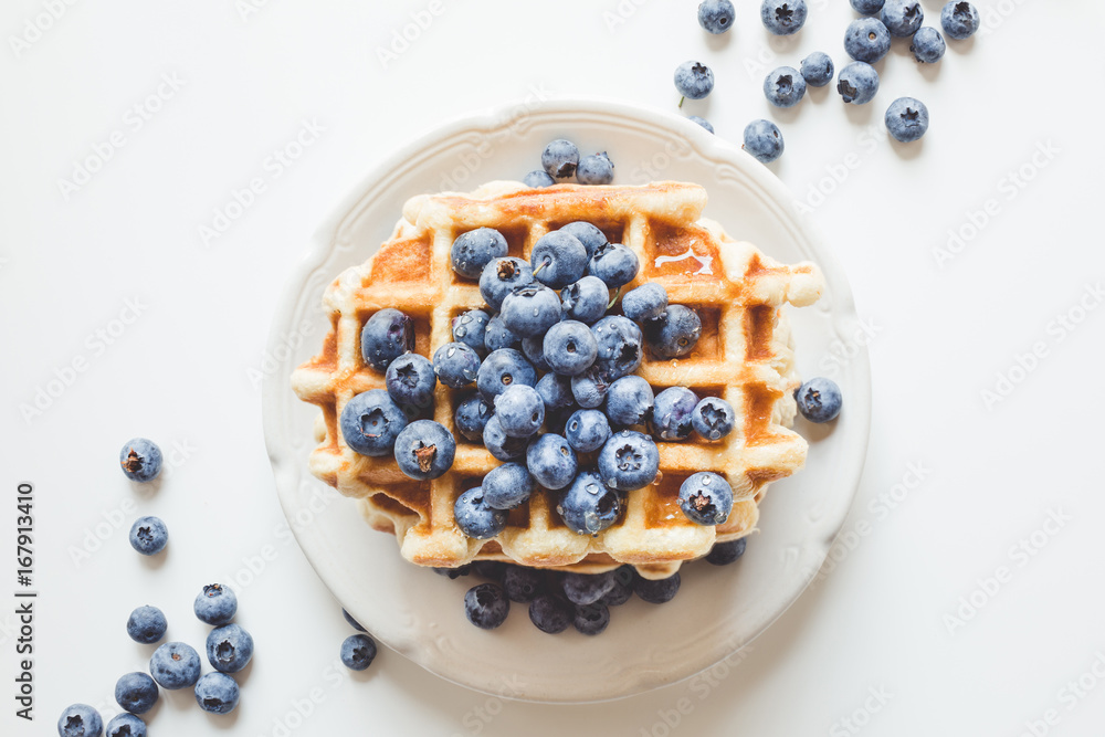 top view of plate of tasty stacked waffles with blueberries top view of plate of tasty stacked waffles with blueberries
