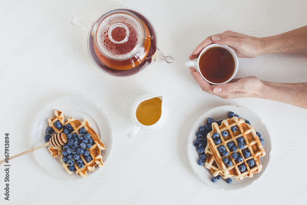 top view of delicious breakfast of tasty waffles and tea top view of delicious breakfast of tasty waffles and tea