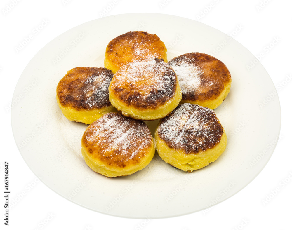 Sweet cottage cheese pancakes with powdered sugar on plate on wh