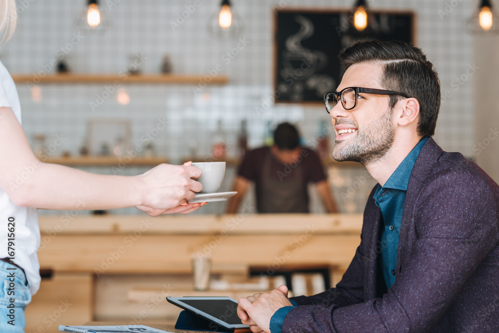 Fototapeta premium waitress with order for businessman in cafe