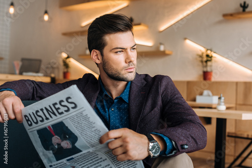 businessman with business newspaper in cafe
