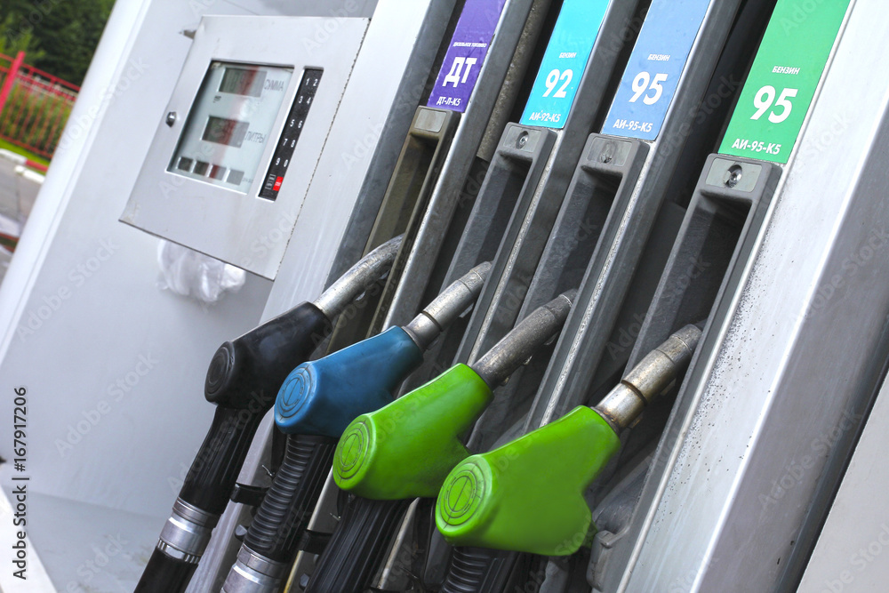 Colorful Petrol pump filling nozzles , Gas station in a service (Inscription in Russian: petrol and fuel type) Colorful Petrol pump filling nozzles , Gas station in a service (Inscription in Russian: petrol and fuel type)