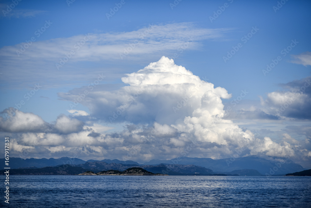 Beautiful landscape on the north sea in norway with clouds on a sunny day