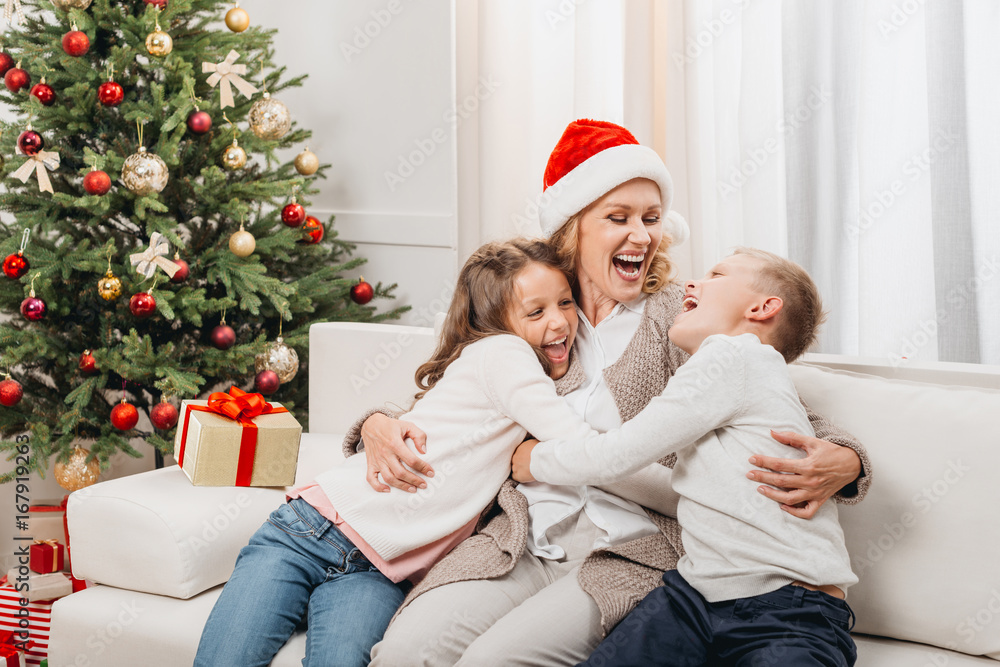 woman and kids in christmas decorated room woman and kids in christmas decorated room