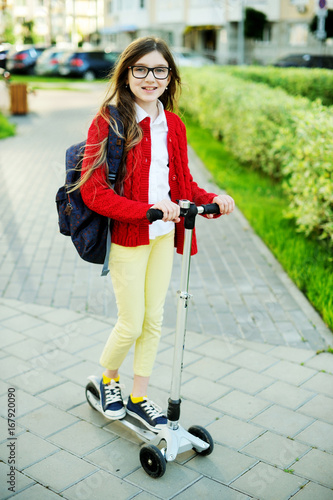 Kid girk on scooter