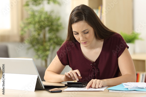 Woman calculating accountancy with a calculator