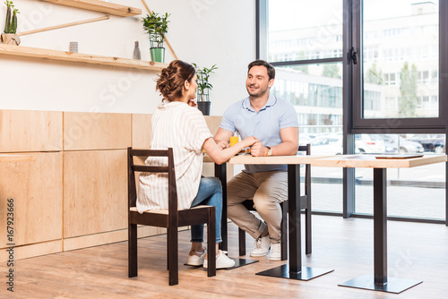 happy young couple dating in modern cafe