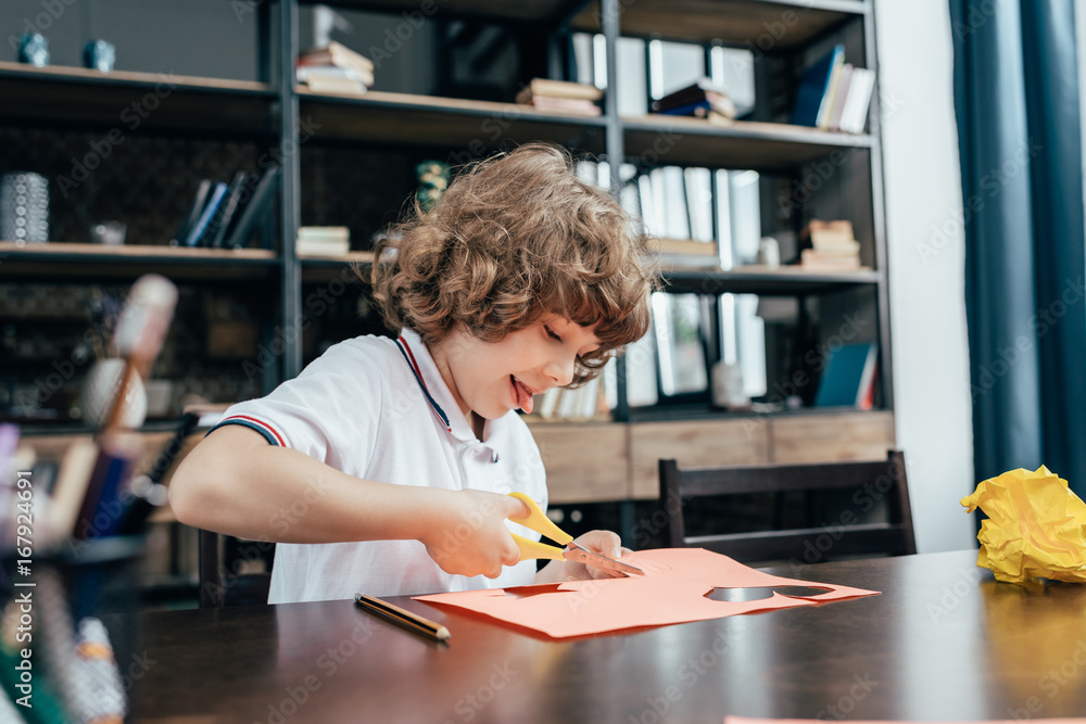 little boy carving paper with scissors little boy carving paper with scissors