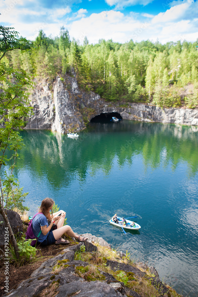 young girl sitting on a rock near the canyon young girl sitting on a rock near the canyon