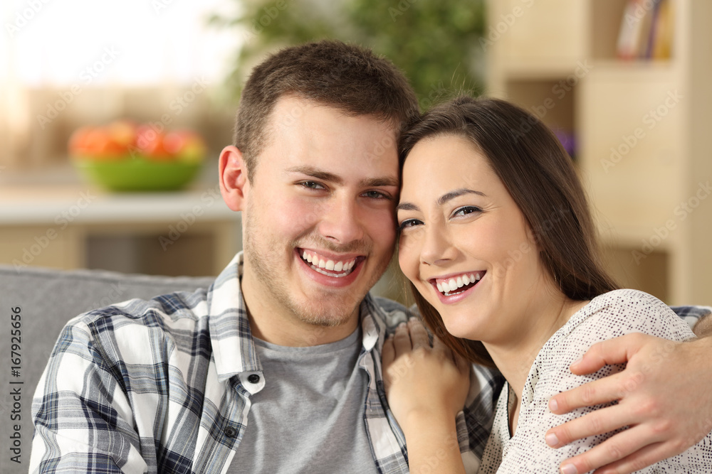 Happy couple with perfect teeth looking at camera Happy couple with perfect teeth looking at camera