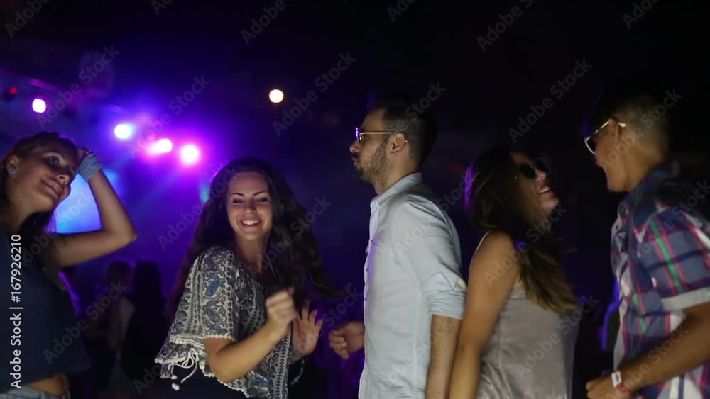 Group of friends having fun and dancing at concert Group of friends having fun and dancing at concert