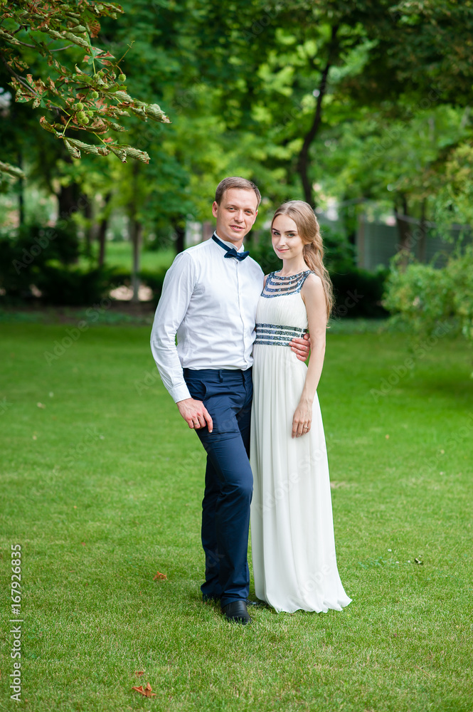 A married couple is walking and hugging in the park. A married couple is walking and hugging in the park.