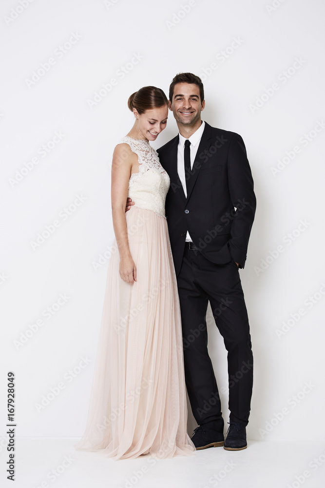 Glamorous couple in formal wear, smiling in studio Glamorous couple in formal wear, smiling in studio