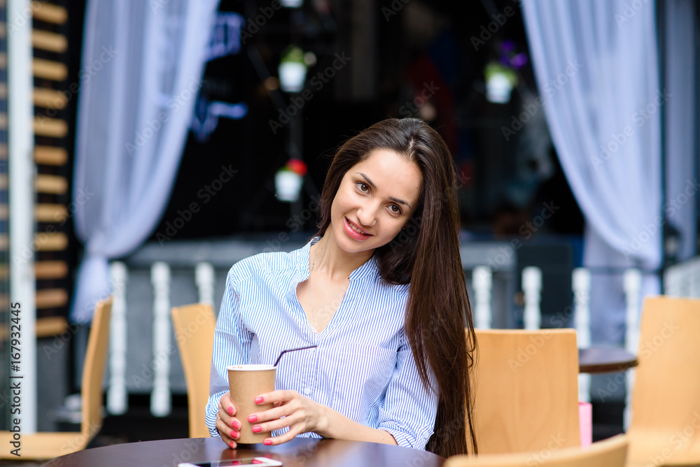Beautiful girl coffee drinkers on the street. Beautiful girl coffee drinkers on the street.