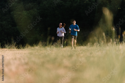 Couple running together on a field