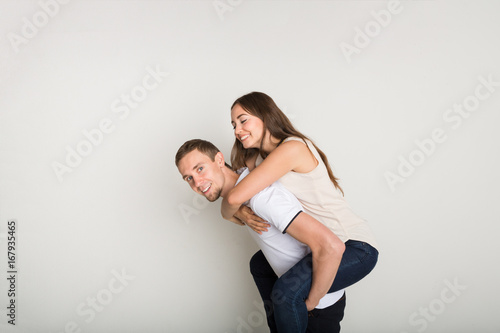 Loving couple, man piggybacking girlfriend