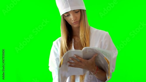 young blonde nurse thumbs a nobebook in uniform photo
