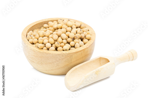 Soybeans in a wooden bowl with wooden spoon on a white background