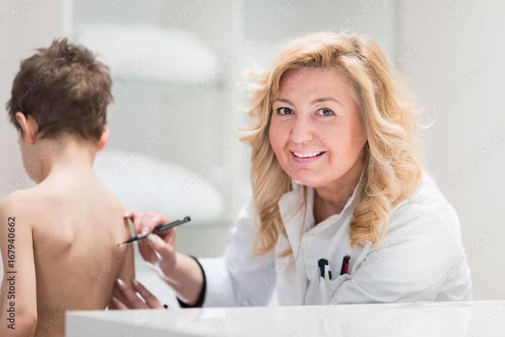Fototapeta premium Physical therapist examining posture of a little boy