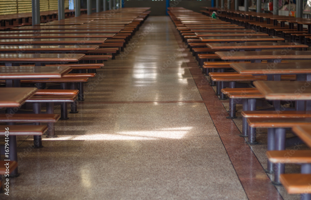 The corridor in the cafeteria with tables on both sides.
