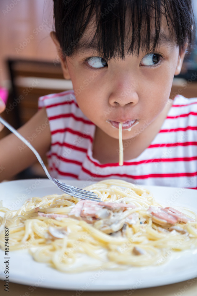 Asian Chinese little girl eating spaghetti Asian Chinese little girl eating spaghetti