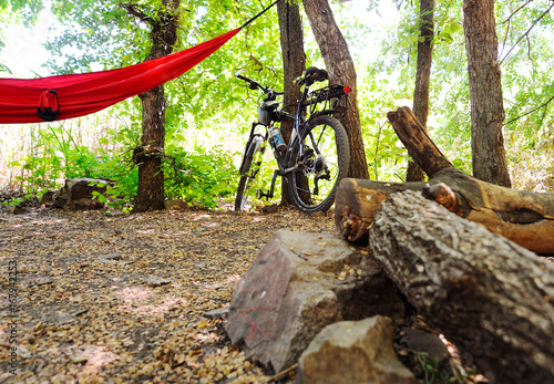 Bicycle and hammock on the background of camping and scaffolding