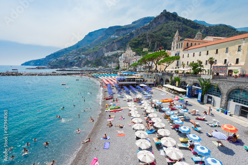 Fototapeta Naklejka Na Ścianę i Meble -  Amalfi town and summer beach with umbrellas , Italy