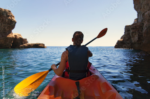 Girl is kayaking on the adriatic sea