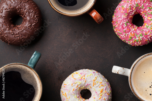 Coffee cups and colorful donuts